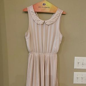 Blush dress with pearl collar and pleated skirt